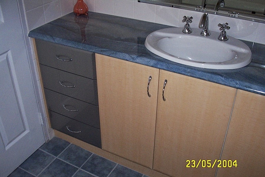 Image is of a vanity with gloss vinyl doors and laminate bench top.